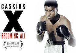 Muhammad Ali poses wearing boxing gloves