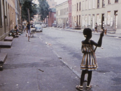 A child playing on a residential street.