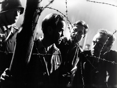 Men behind barbed wire.