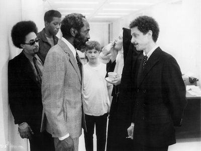 A group of people standing in an office.