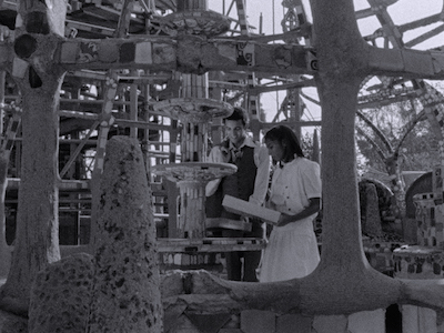 A man and woman visiting the Watts Towers.