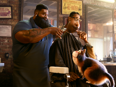 An animated scene of a man with a cat on his lap getting a haircut at a barbershop.