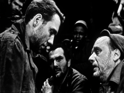 A group of men talking to each other.