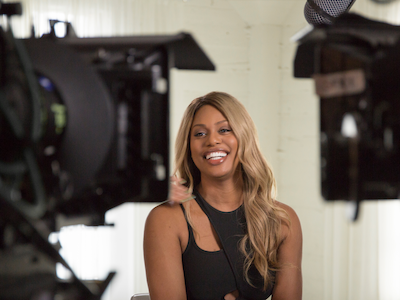 Laverne Cox smiling in front of cameras.