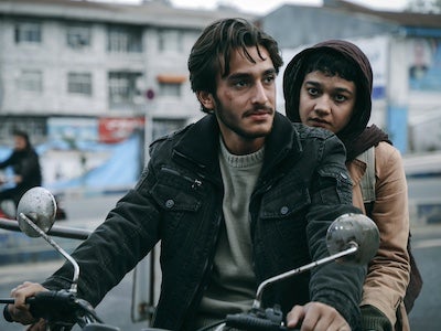 A man and woman on a bicycle.