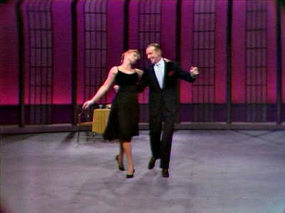 Barrie Chase and Fred Astaire dancing in a TV studio.