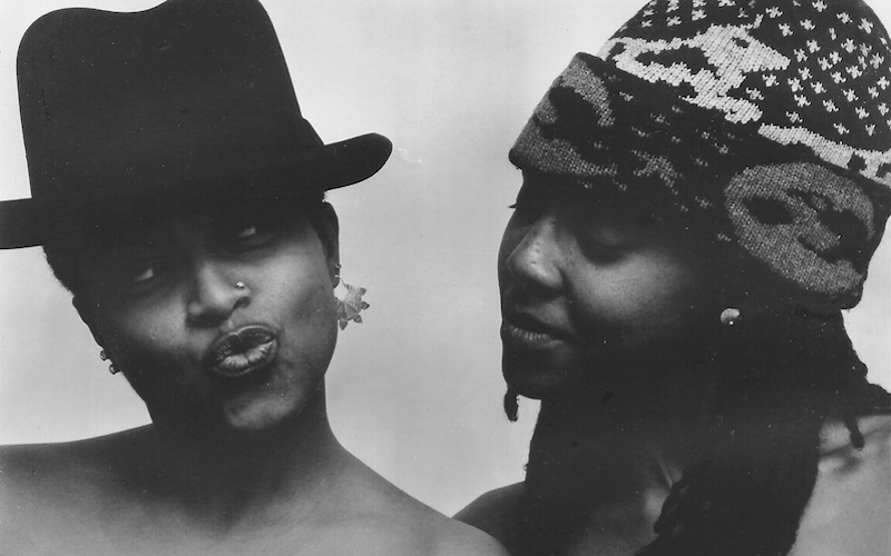 Closeup of two women smiling in hats.