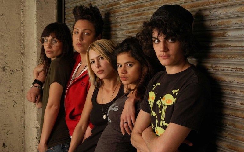 Five women sitting and looking at the camera.