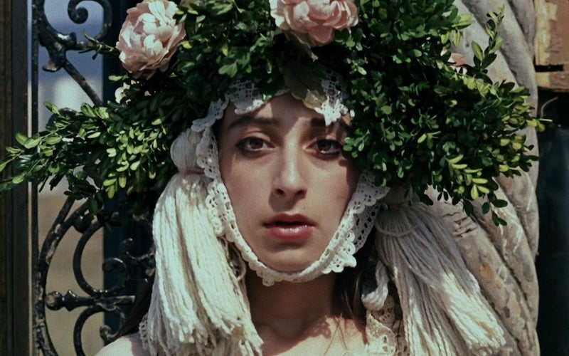 A woman wearing a floral headdress.