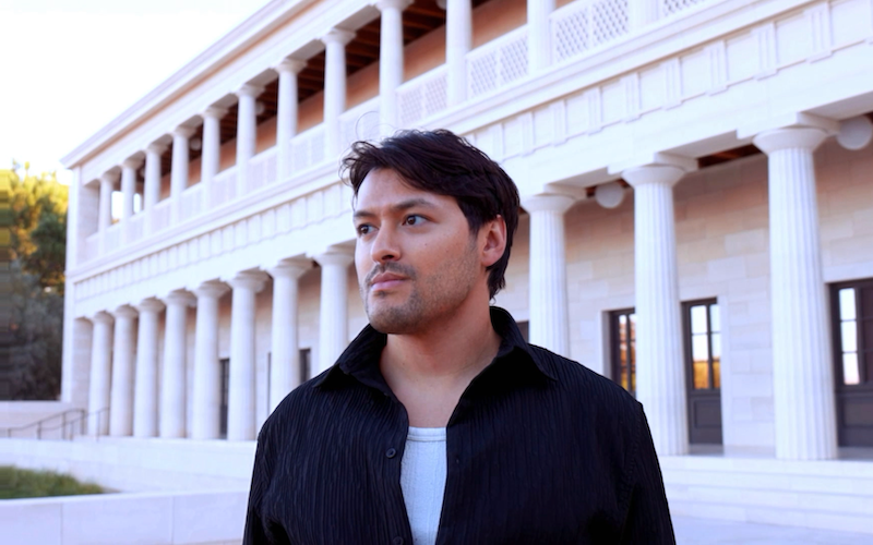 Esteban Arellano standing outside a large building.