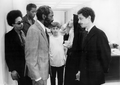 A group of people standing in an office.