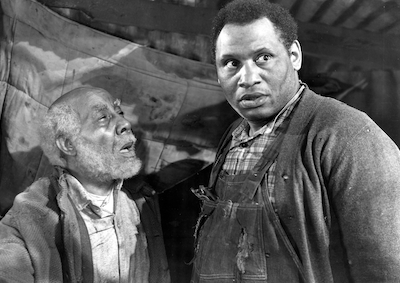 Paul Robeson standing next to a man.