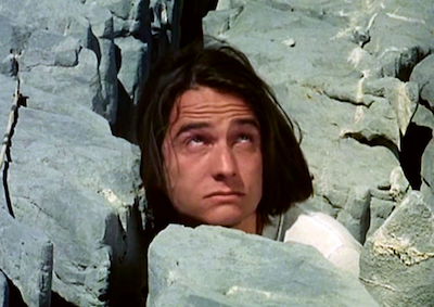 Jean-Pierre Léaud surrounded by large stones.