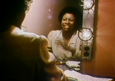 Betty Carter smiling in the mirror