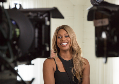 Laverne Cox smiling in front of cameras.