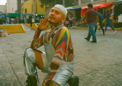 A person posing on a street.