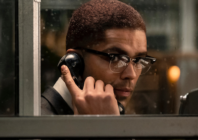 Kingsley Ben-Adir as Malcolm X talking on a phone.