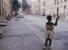 A child playing on a residential street.