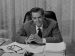 Desi Arnaz sitting at a desk
