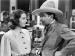 Actors Ann Dvorak and Richard Barthelmess looking at each other, in old Western clothing.
