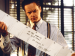 Tim Robbins reading a long sheet of paper.