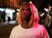 Michaela Coel standing outside at night.